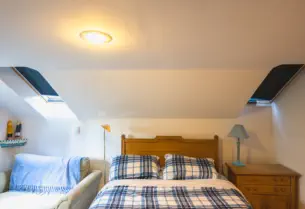 queen bed with skylights in cozy getaway