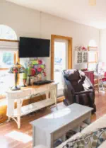 tv massage chair and door to patio in living room of suite