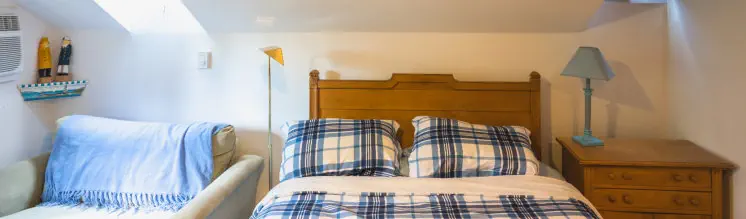 queen bed with skylights in cozy getaway