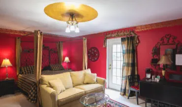 room with door to balcony and small breakfast table