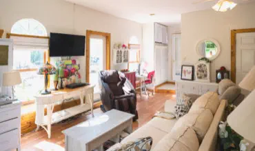 tv massage chair and door to patio in living room of suite