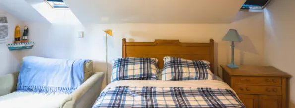 queen bed with skylights in cozy getaway