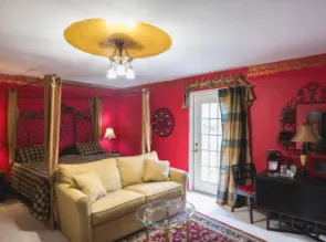 room with door to balcony and small breakfast table